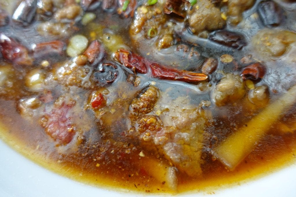 Spicy pork rolls in pan